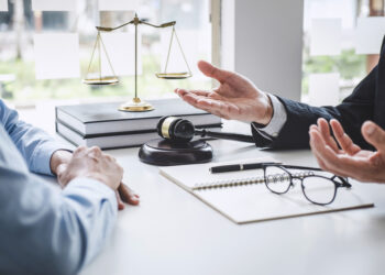 Consultation and conference of Male lawyers and professional businesswoman working and discussion having at law firm in office. Concepts of law, Judge gavel with scales of justice.